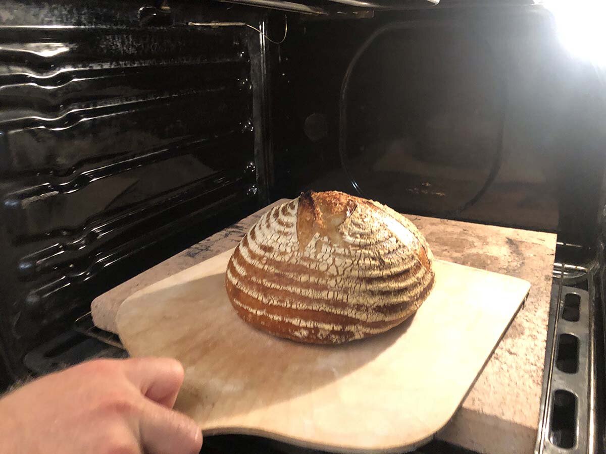 Slide the peel underneath the bread to remove it